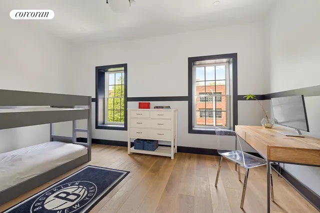 a bedroom with furniture and a wooden floor
