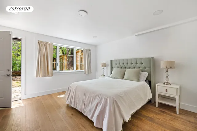 a kitchen with stainless steel appliances granite countertop a sink a stove and a wooden floors