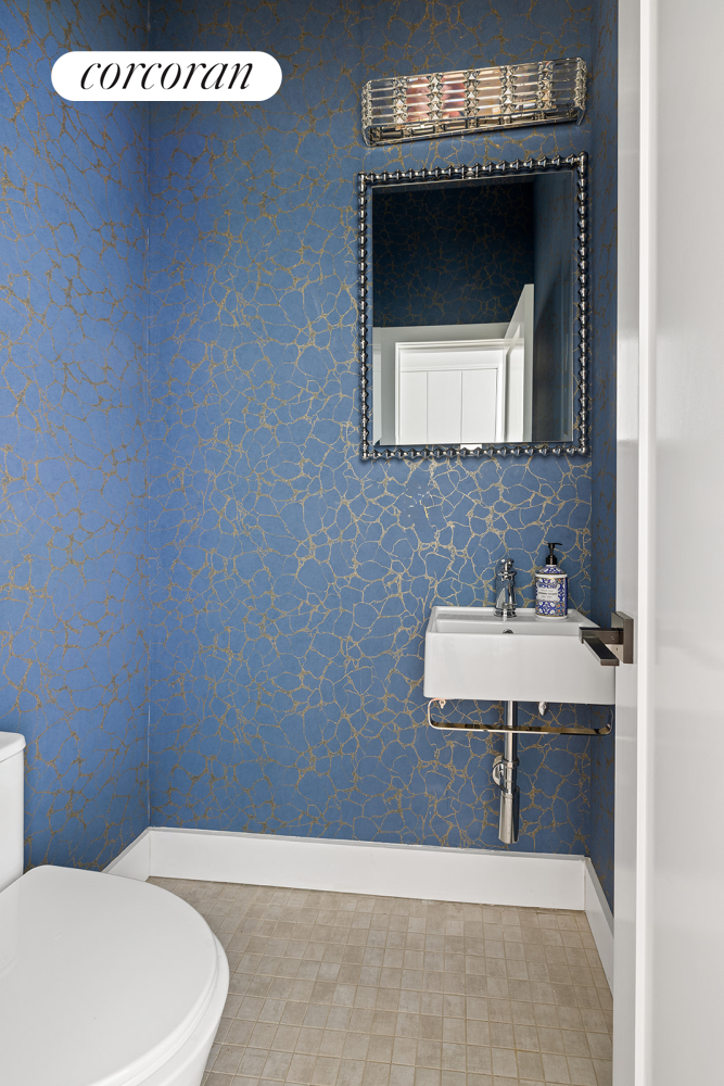 416 Halsey Street Brooklyn, NY 11233 - Photo 5 of 17 a bathroom with a sink a toilet and mirror