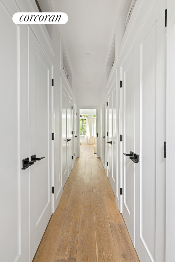 416 Halsey Street Brooklyn, NY 11233 - Photo 6 of 17 a view of a hallway with wooden floor and closet area