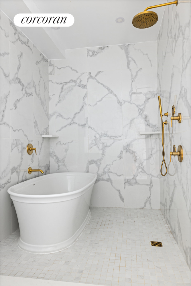 416 Halsey Street Brooklyn, NY 11233 - Photo 9 of 17 a white bath tub sitting in a bathroom