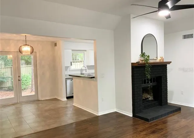 a view of a kitchen with a sink window and wooden floor