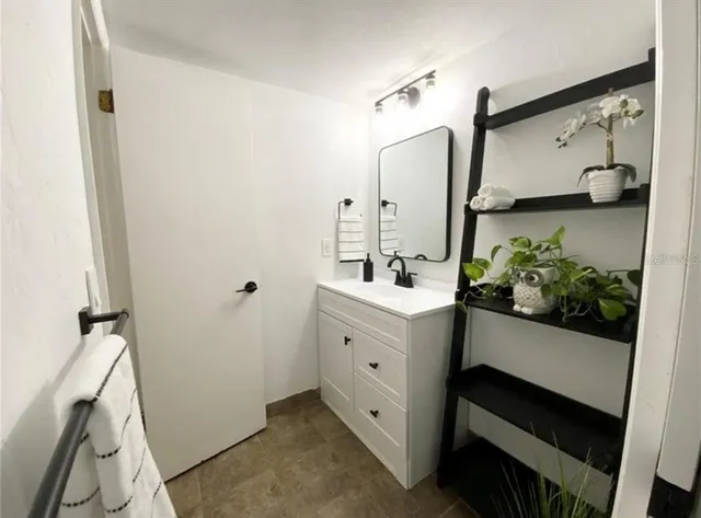 a bathroom with a double vanity sink and mirror