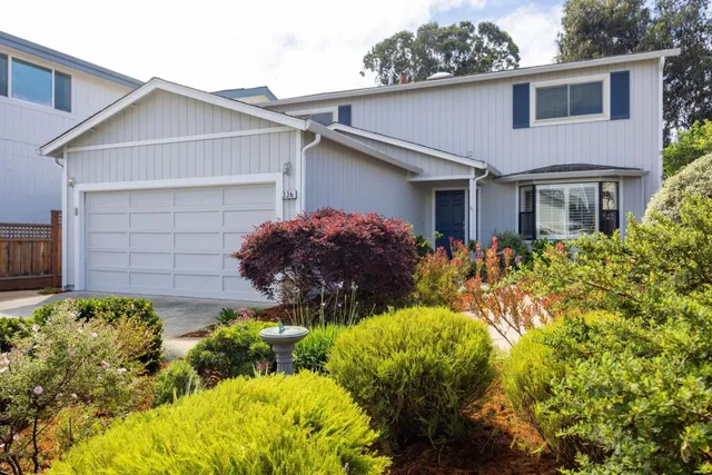 a front view of house with yard and green space