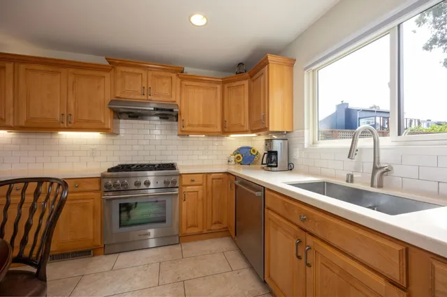 a kitchen with a sink and a stove top oven
