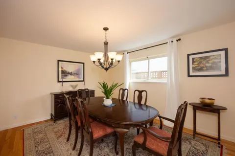 a view of a dining room with furniture window and wooden floor
