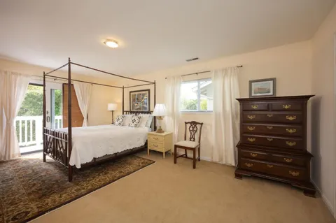 a bedroom with a bed a table and chair