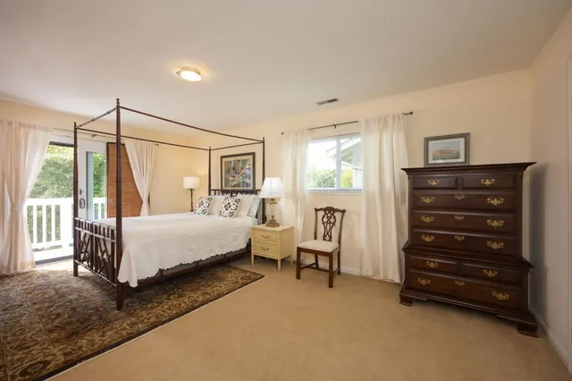 a bedroom with a bed a table and chair