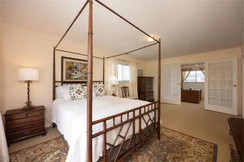 a bedroom with bed and a table