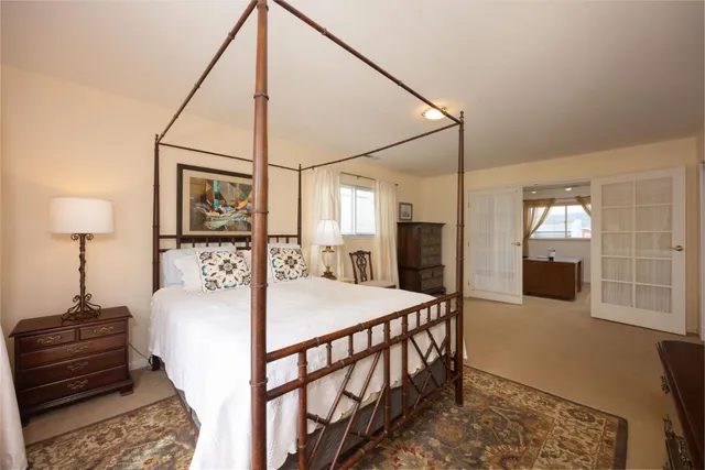 a bedroom with bed and a table