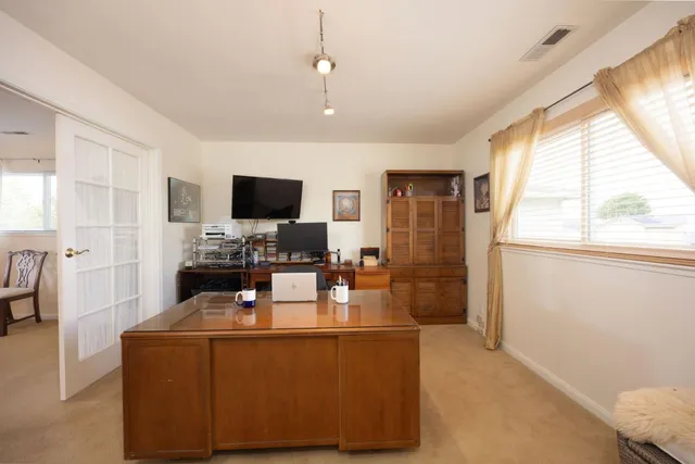 a living room with fireplace furniture and a flat screen tv