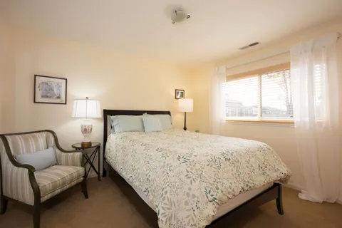 a bedroom with a bed and a couch