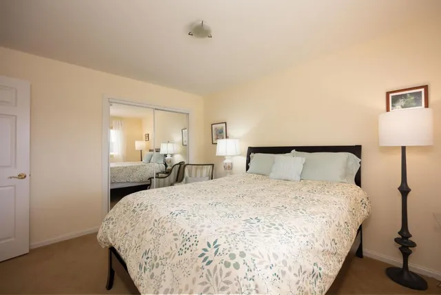 a bedroom with a bed and a night stand