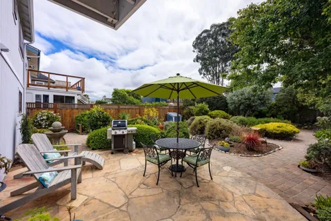 a view of backyard with outdoor seating and trees