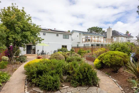 a view of a house with a yard and sitting area