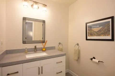 a bathroom with a granite countertop sink a mirror and a