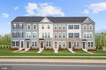 131 Drydock Way, Unit H Brooklyn, MD 21225 - Photo 1 of 13 a view of a big yard in front of a brick building
