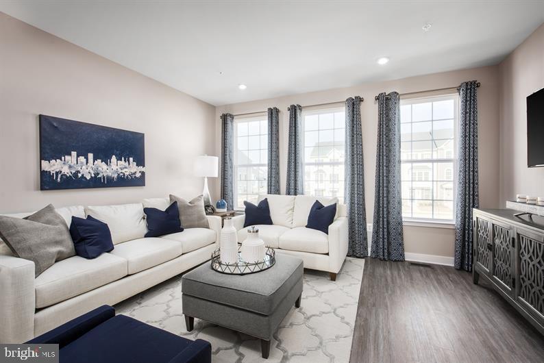 131 Drydock Way, Unit H Brooklyn, MD 21225 - Photo 4 of 13 a living room with furniture and a large window