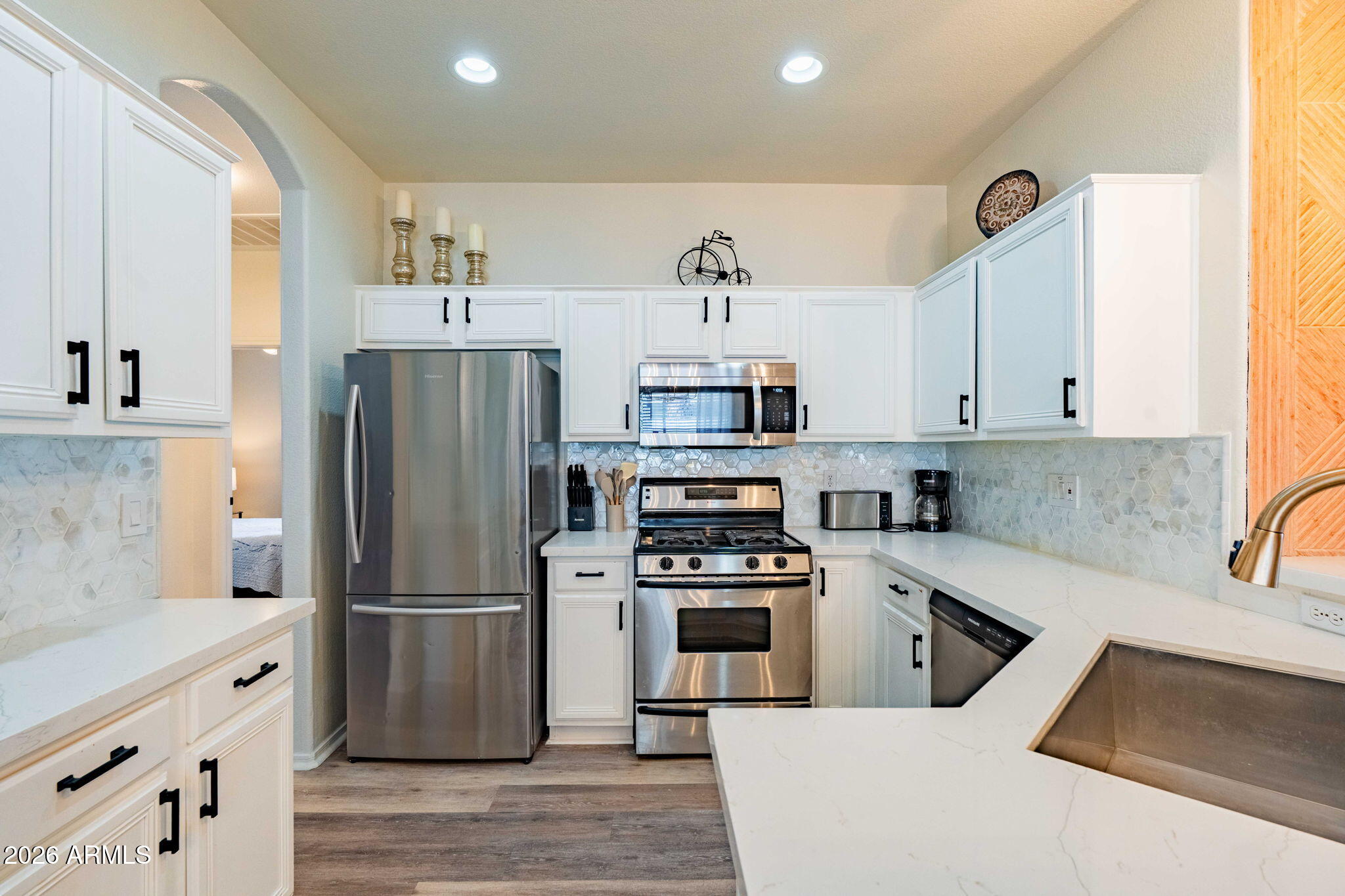 3674 South Joshua Tree Lane Gilbert, AZ 85297 - Photo 11 of 30 a kitchen with a refrigerator a sink and a stove