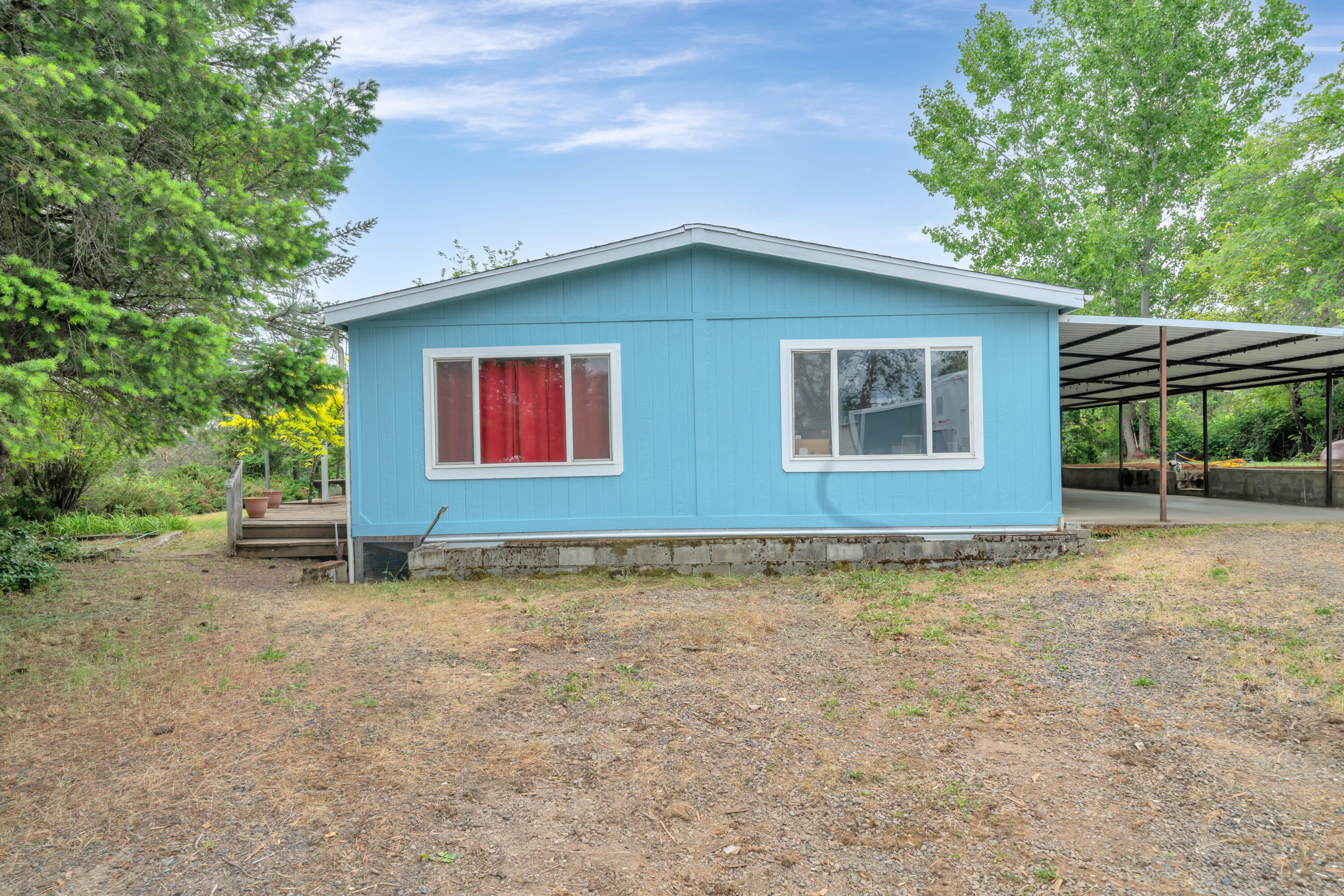 12107 Meadows Road White City, OR 97503 - Photo 2 of 36 a house with trees in front of it