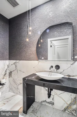 a bathroom with a sink a toilet and a mirror