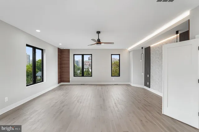 a living room with furniture and a floor to ceiling window