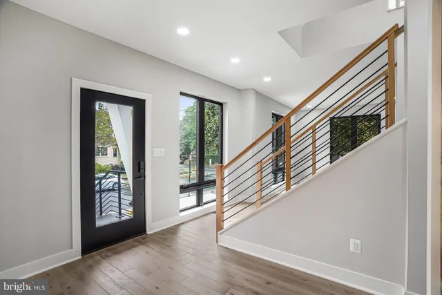 a view of a kitchen with furniture and wooden floor
