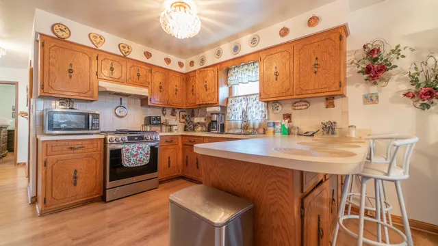 a kitchen with stainless steel appliances granite countertop a sink and cabinets