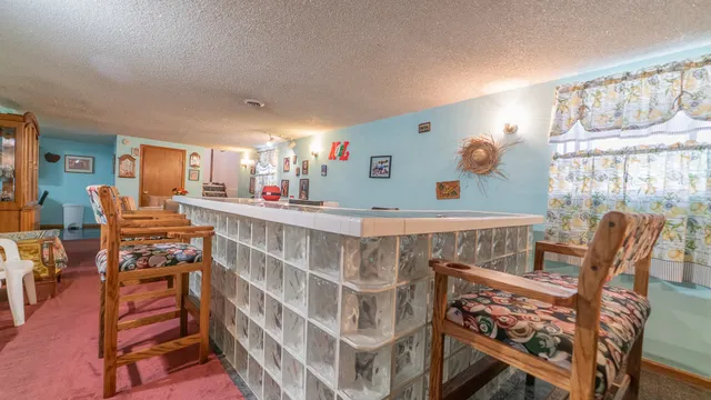 a view of a dining room with furniture and a large window
