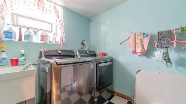 a utility room with a sink washer and dryer