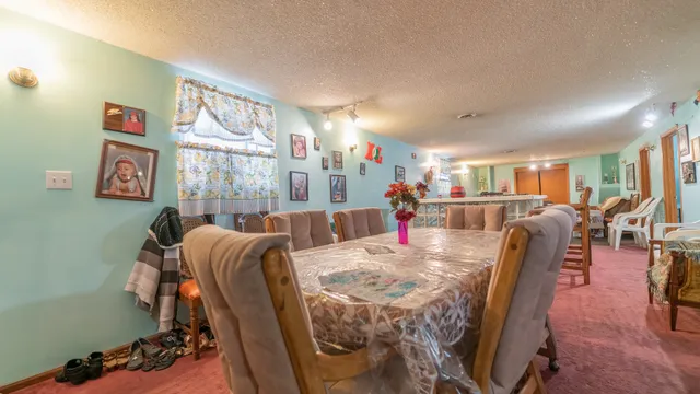 a living room with furniture and a dining table