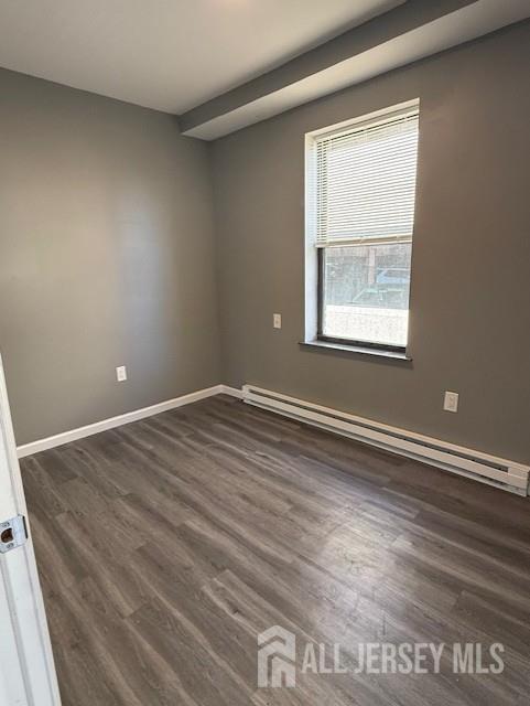 439 Barclay Street Perth Amboy, NJ 08861 - Photo 3 of 7 an empty room with wooden floor and windows
