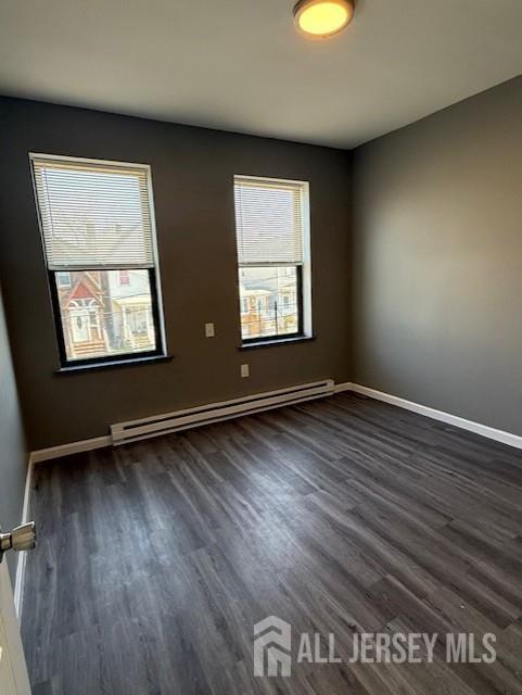 439 Barclay Street Perth Amboy, NJ 08861 - Photo 4 of 7 an empty room with wooden floor and windows