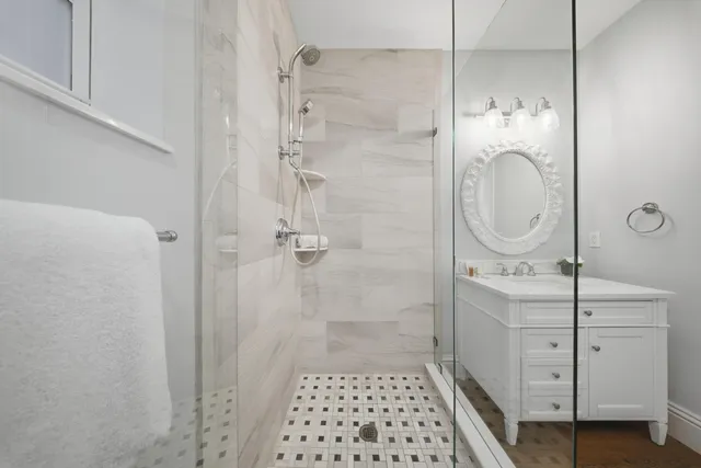 a spacious bathroom with a double vanity sink and a mirror