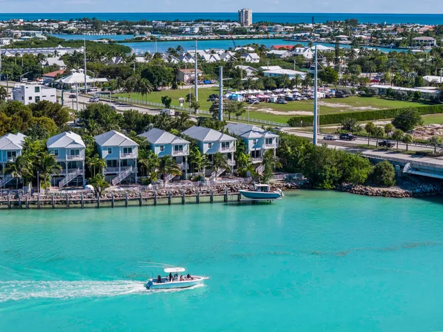 a dining room with furniture large windows and wooden floor