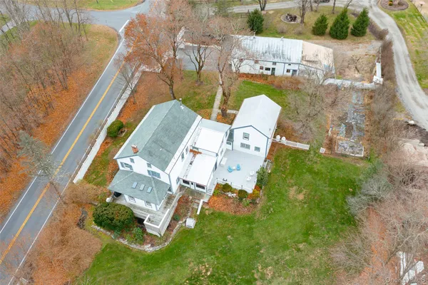 an aerial view of a house with a garden and swimming pool