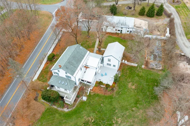 an aerial view of a house with a garden and swimming pool