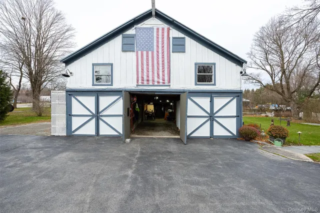 a view of a house with a yard and garage