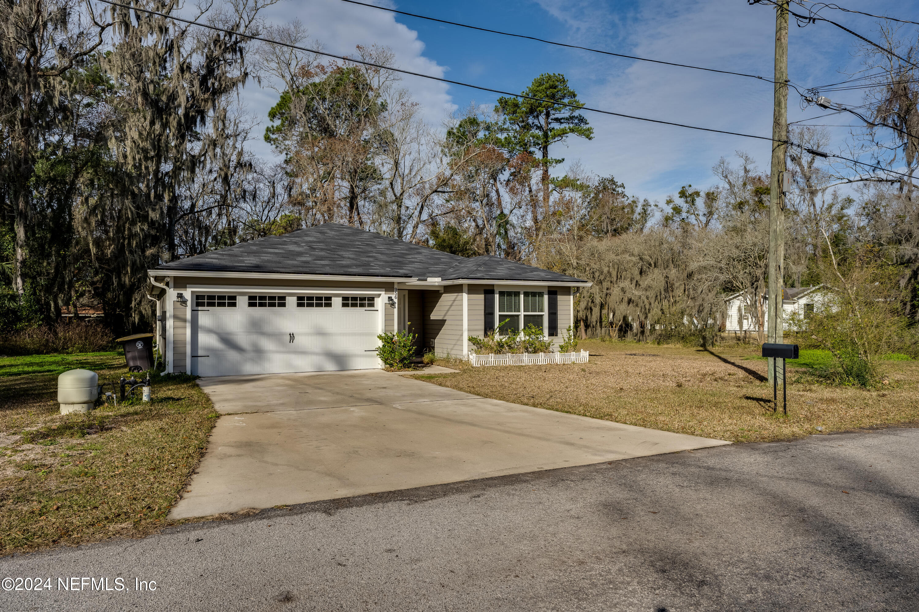 956 Revels Road Jacksonville, FL 32205 - Photo 2 of 26 a front view of a house with a yard and garage