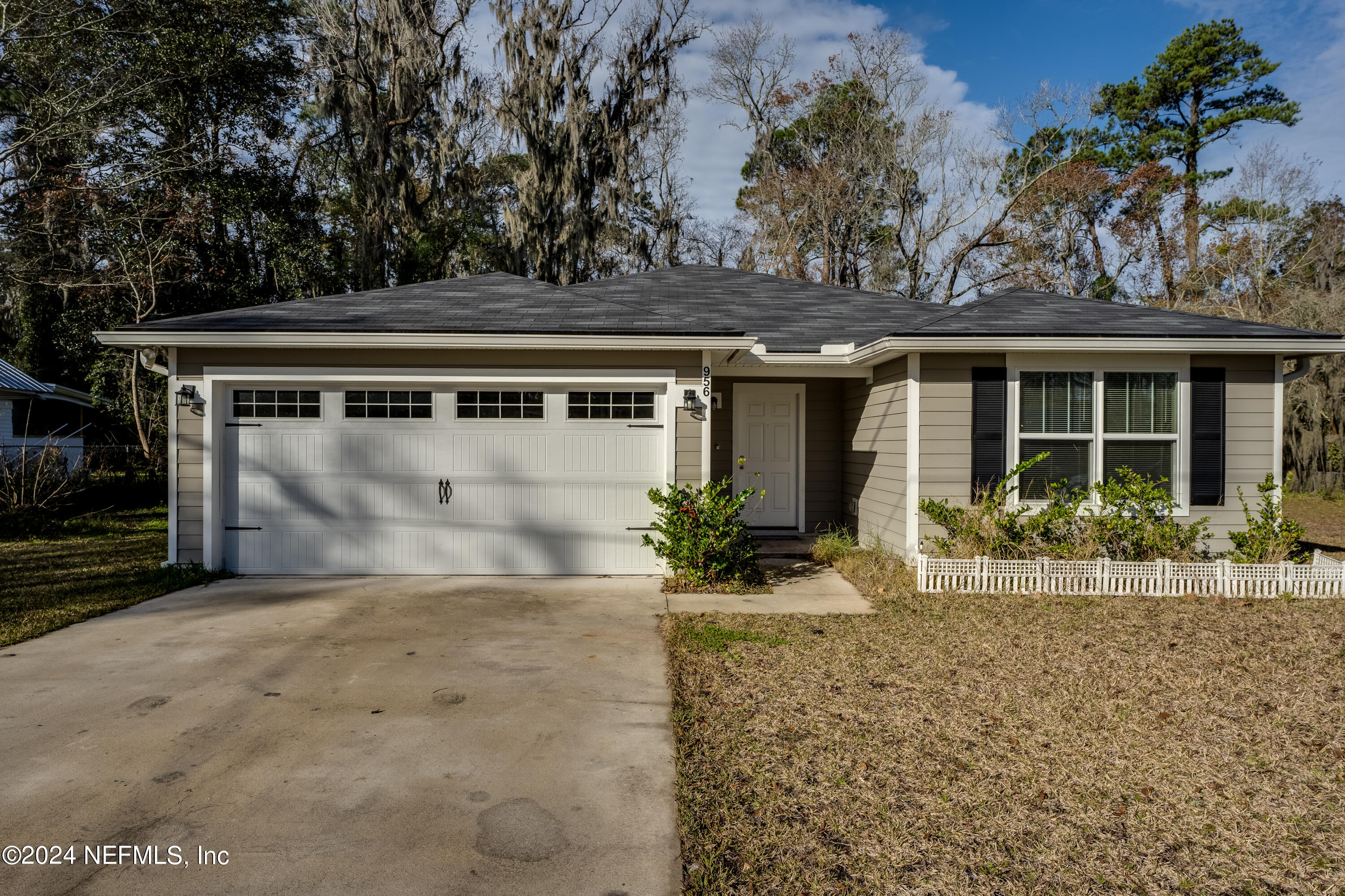 956 Revels Road Jacksonville, FL 32205 - Photo 4 of 26 a front view of a house with a yard and potted plants