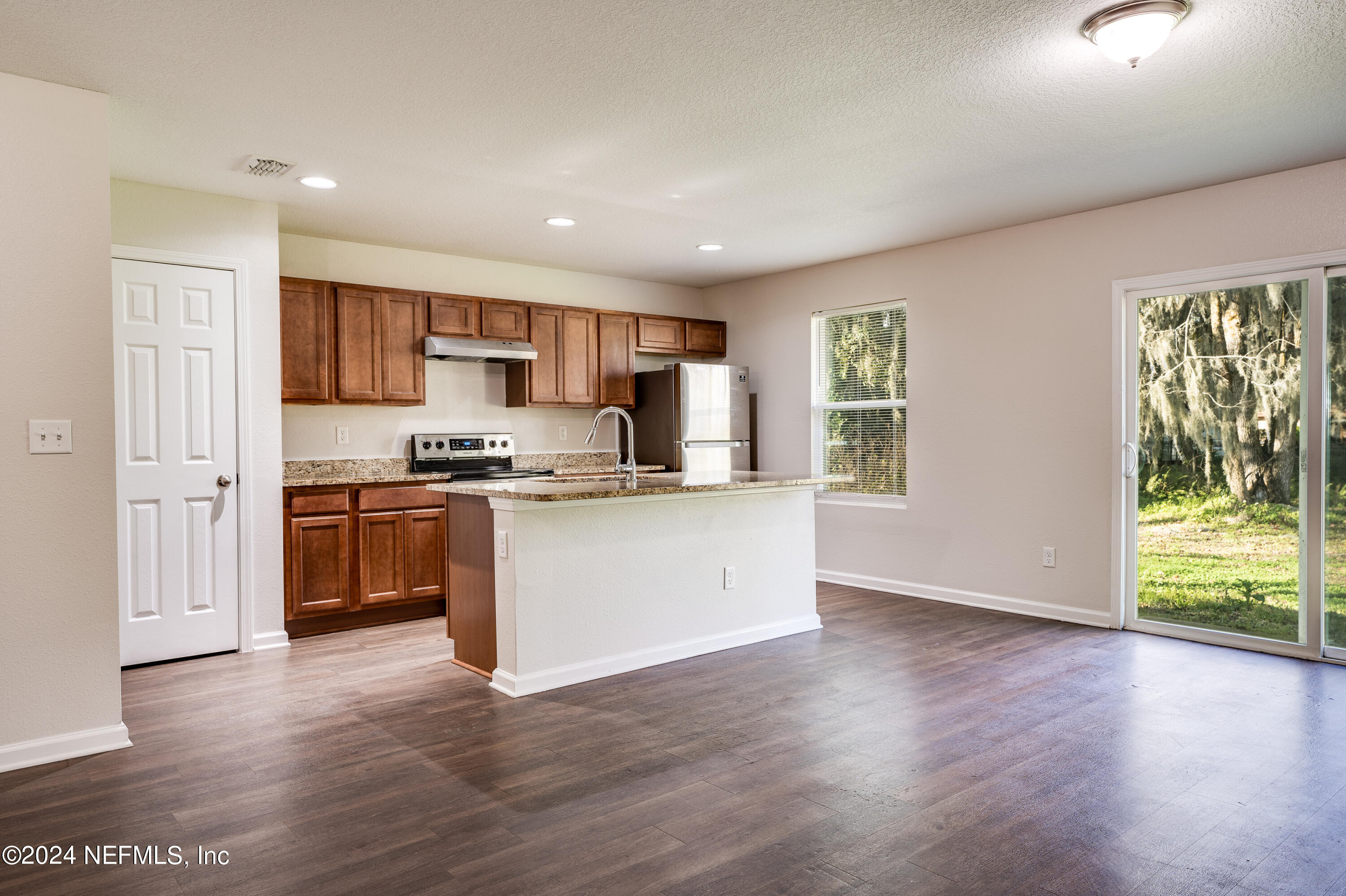 956 Revels Road Jacksonville, FL 32205 - Photo 7 of 26 a kitchen with stainless steel appliances granite countertop a stove a sink and a refrigerator