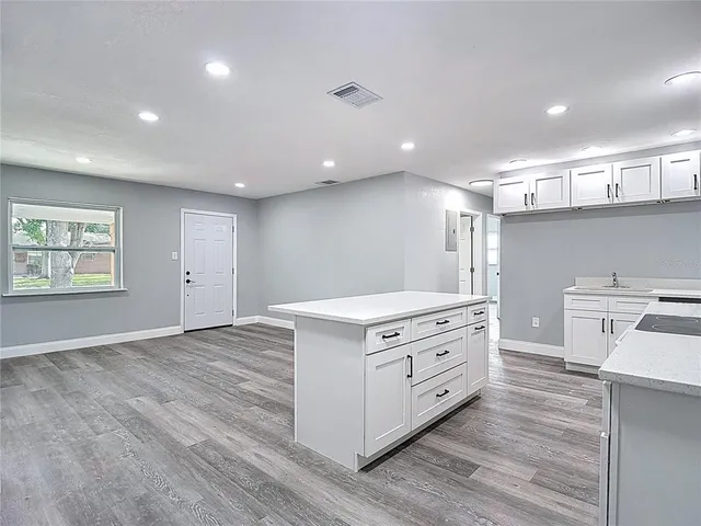 a view of cabinets a sink and dishwasher in a white cabinet