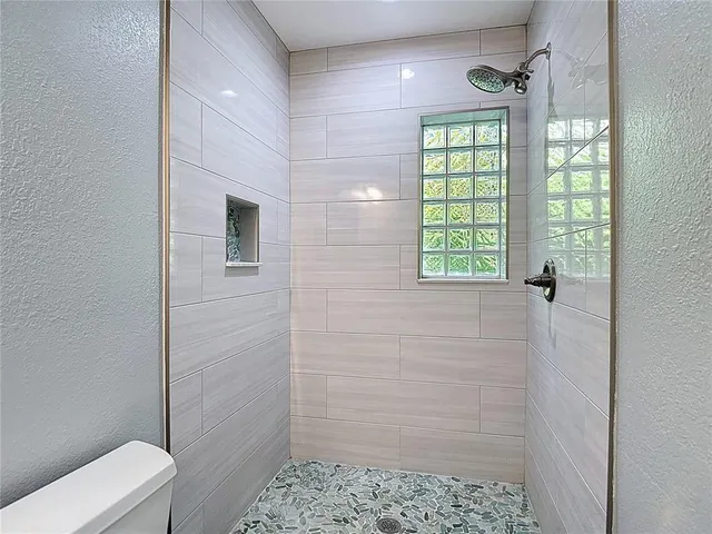 a view of an empty room and wooden floor