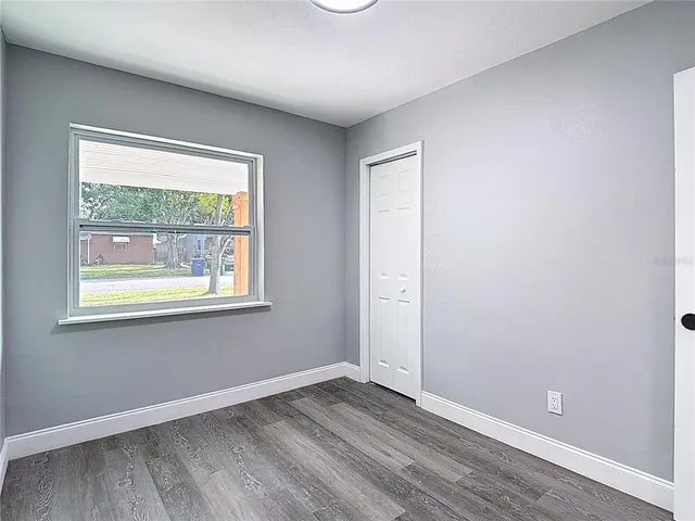 a view of a livingroom with wooden floor and a ceiling fan