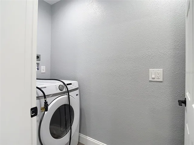 an aerial view of residential houses with outdoor space and ocean view