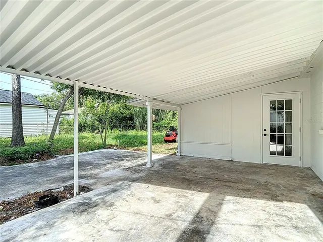 an aerial view of residential houses with outdoor space and trees