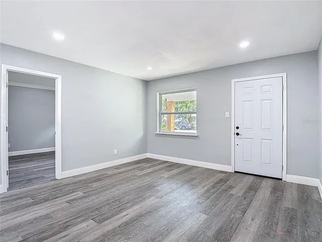 a large kitchen with stainless steel appliances granite countertop a large stove a sink dishwasher and a refrigerator with wooden floor