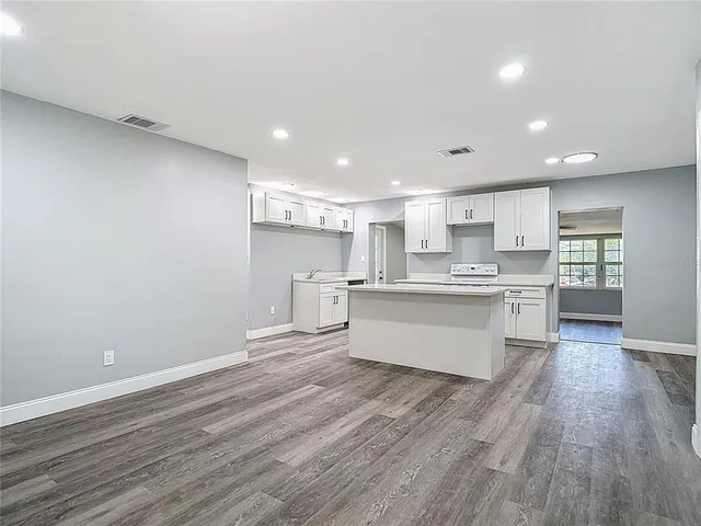 a kitchen with stainless steel appliances granite countertop a stove and a sink