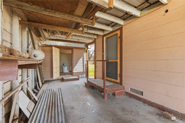 a view of a porch with wooden floor and furniture
