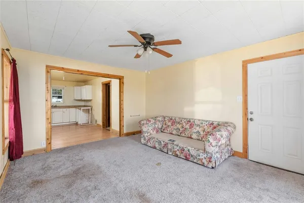 a spacious bedroom with a bed and a chandelier